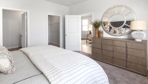 The primary bedroom features an ensuite bathroom with a double vanity, granite countertops, and walk-in closet . Each bedroom has carpeted floors along with a closet that are versatile to fit your family's needs, whether they become bedrooms or home offices.