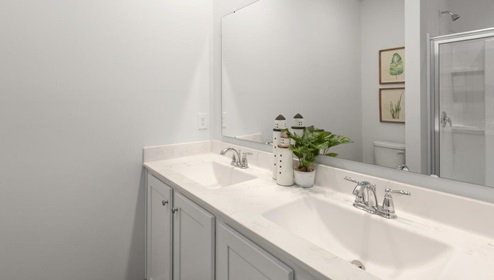 The primary bedroom features an ensuite bathroom with a double vanity, granite countertops, and walk-in closet . Each bedroom has carpeted floors along with a closet that are versatile to fit your family's needs, whether they become bedrooms or home offices.