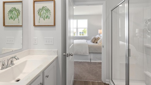 The primary bedroom features an ensuite bathroom with a double vanity, granite countertops, and walk-in closet . Each bedroom has carpeted floors along with a closet that are versatile to fit your family's needs, whether they become bedrooms or home offices.