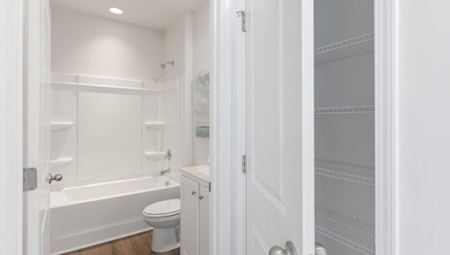 The primary bedroom features an ensuite bathroom with a double vanity, granite countertops, and walk-in closet . Each bedroom has carpeted floors along with a closet that are versatile to fit your family's needs, whether they become bedrooms or home offices.