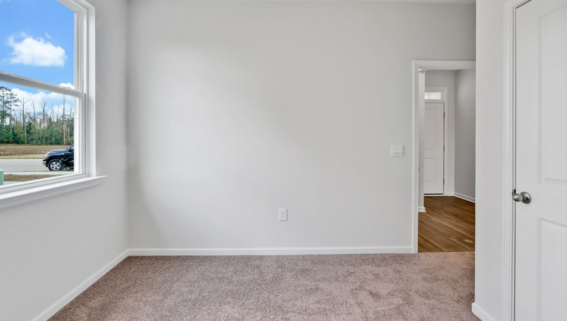 At the back, the Primary Suite provides privacy with a large walk-in closet and walk-in shower. This floor plan combines comfort and convenience, making it a great choice for those seeking an open layout and a 2-car garage.
