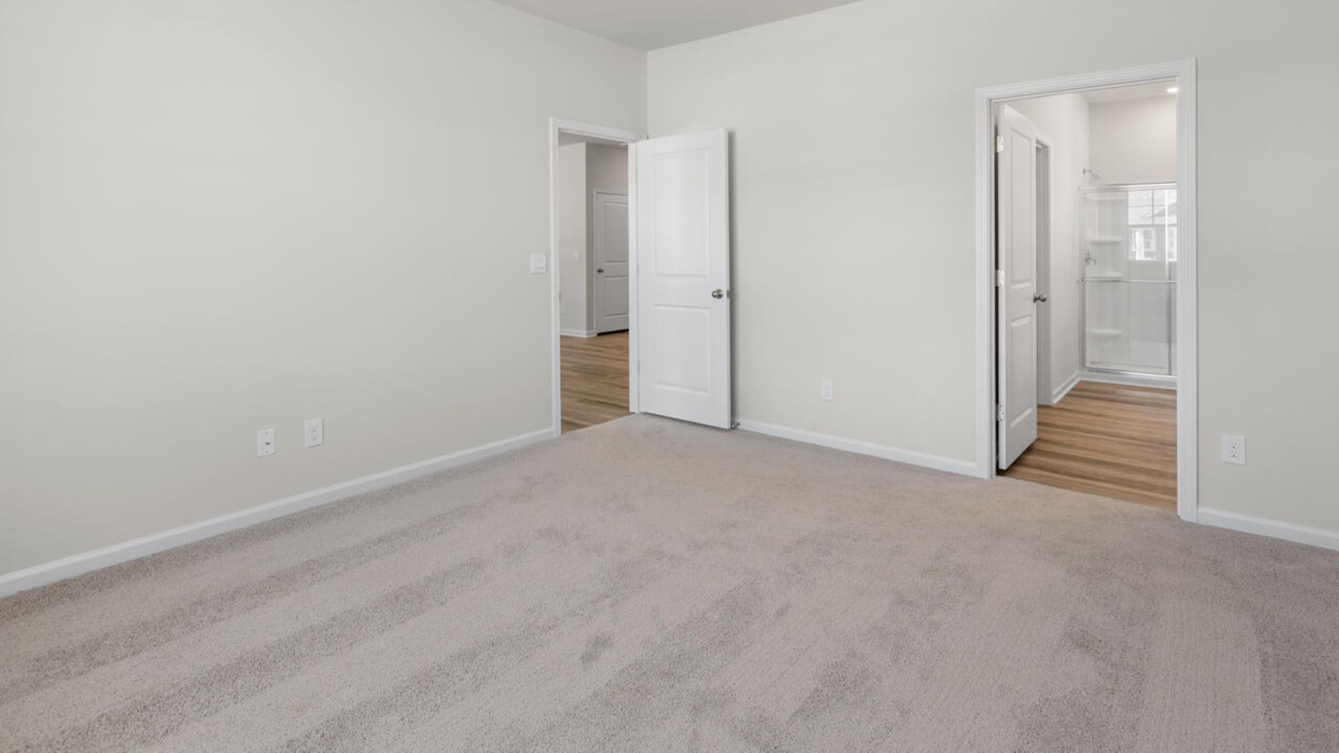 At the back, the Primary Suite provides privacy with a large walk-in closet and walk-in shower. This floor plan combines comfort and convenience, making it a great choice for those seeking an open layout and a 2-car garage.