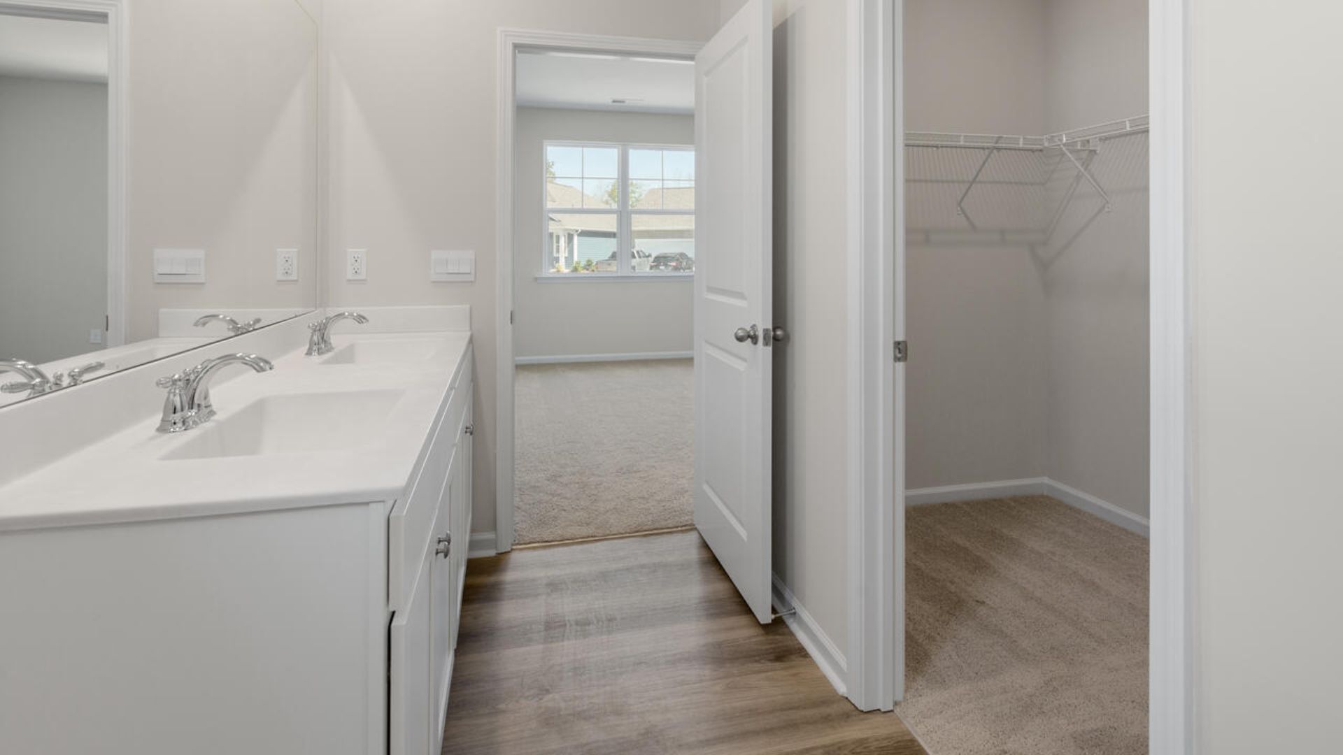 At the back, the Primary Suite provides privacy with a large walk-in closet and walk-in shower. This floor plan combines comfort and convenience, making it a great choice for those seeking an open layout and a 2-car garage.