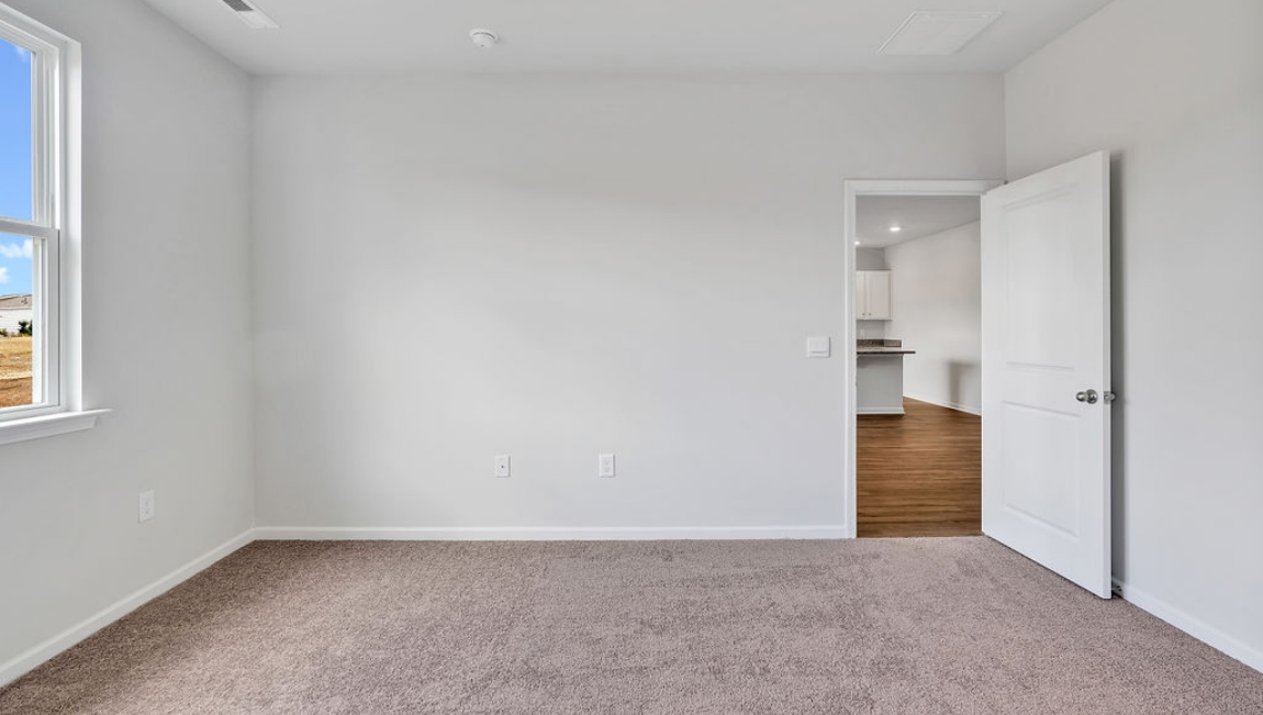 At the back, the Primary Suite provides privacy with a large walk-in closet and walk-in shower. This floor plan combines comfort and convenience, making it a great choice for those seeking an open layout and a 2-car garage.