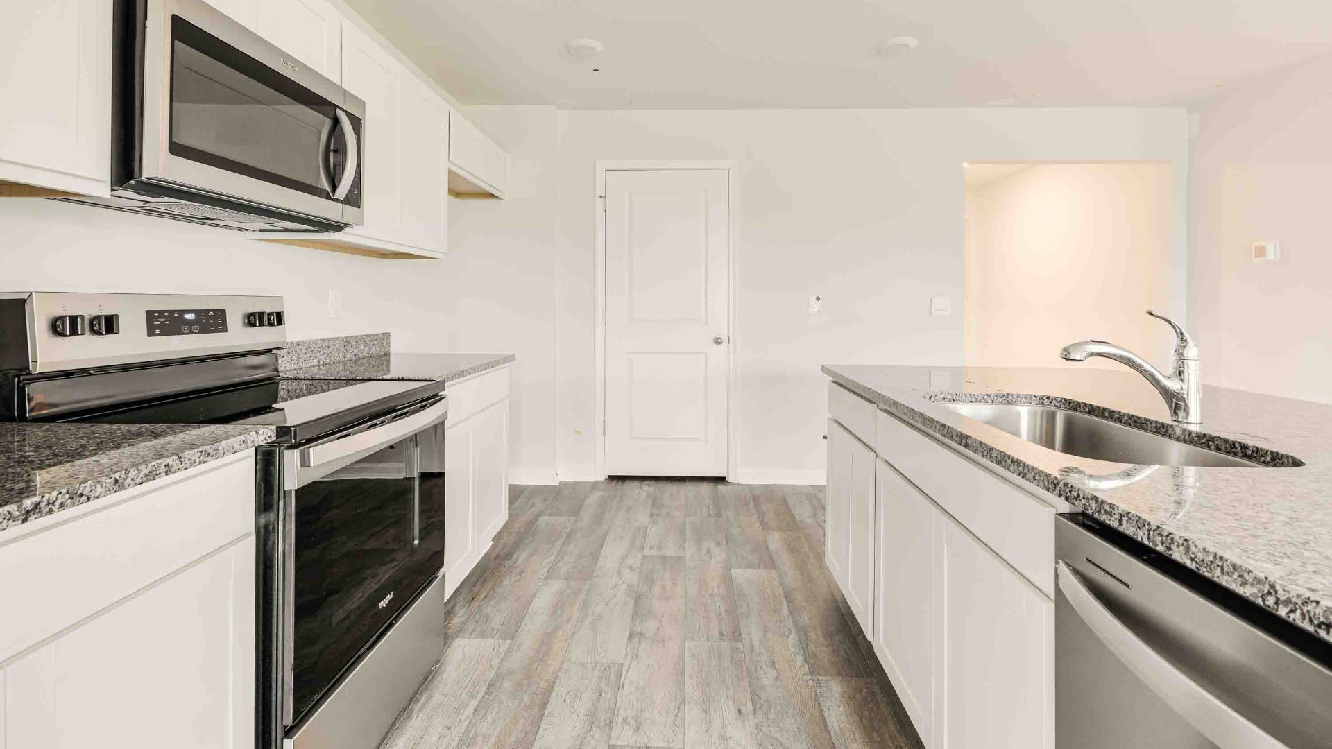 The kitchen features a large island, tile backsplash, granite countertops, and stainless steel appliances, which are sure to both turn heads and make meal prep easy. You’ll never be too far from the action with the living and dining area right there.