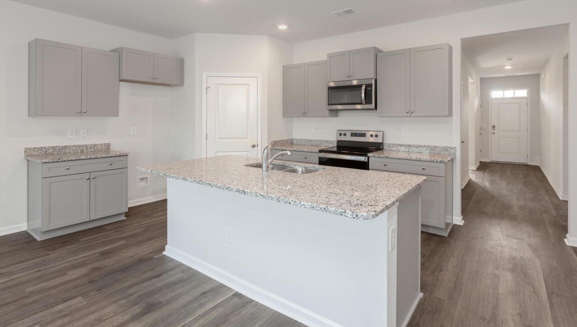 The kitchen features beautiful cabinets, granite countertops, and stainless steel appliances, which are sure to both turn heads and make meal prep easy. You’ll never be too far from the action with the living and dining area right there.