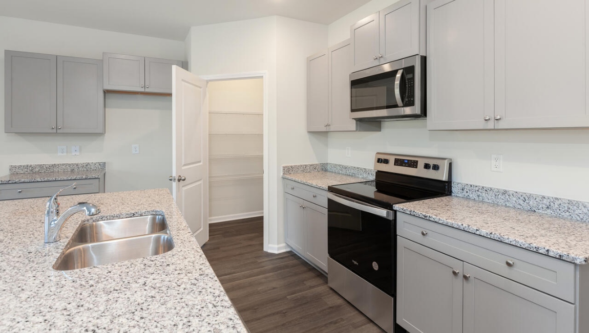 The kitchen features beautiful cabinets, granite countertops, and stainless steel appliances, which are sure to both turn heads and make meal prep easy. You’ll never be too far from the action with the living and dining area right there.