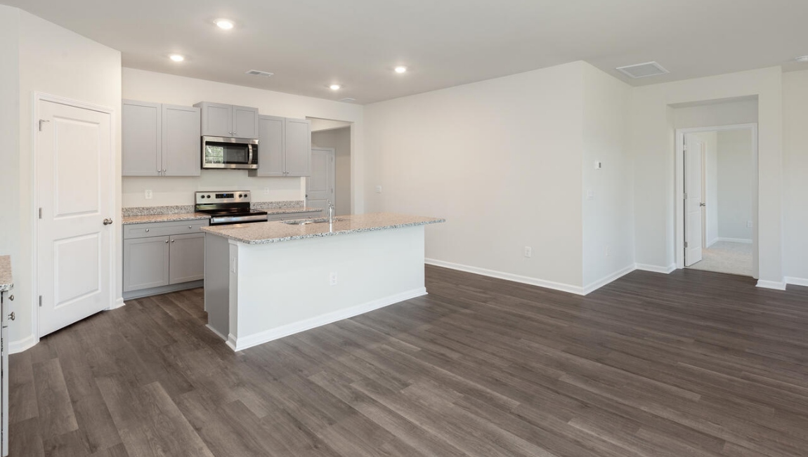 The kitchen features beautiful cabinets, granite countertops, and stainless steel appliances, which are sure to both turn heads and make meal prep easy. You’ll never be too far from the action with the living and dining area right there.