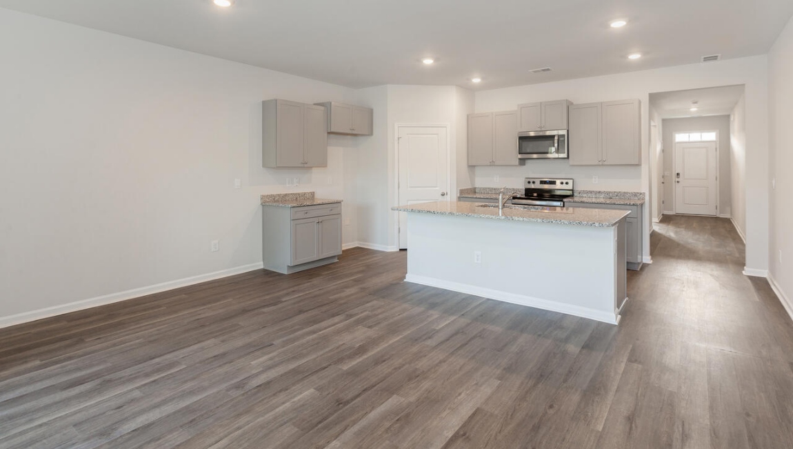 The kitchen features beautiful cabinets, granite countertops, and stainless steel appliances, which are sure to both turn heads and make meal prep easy. You’ll never be too far from the action with the living and dining area right there.