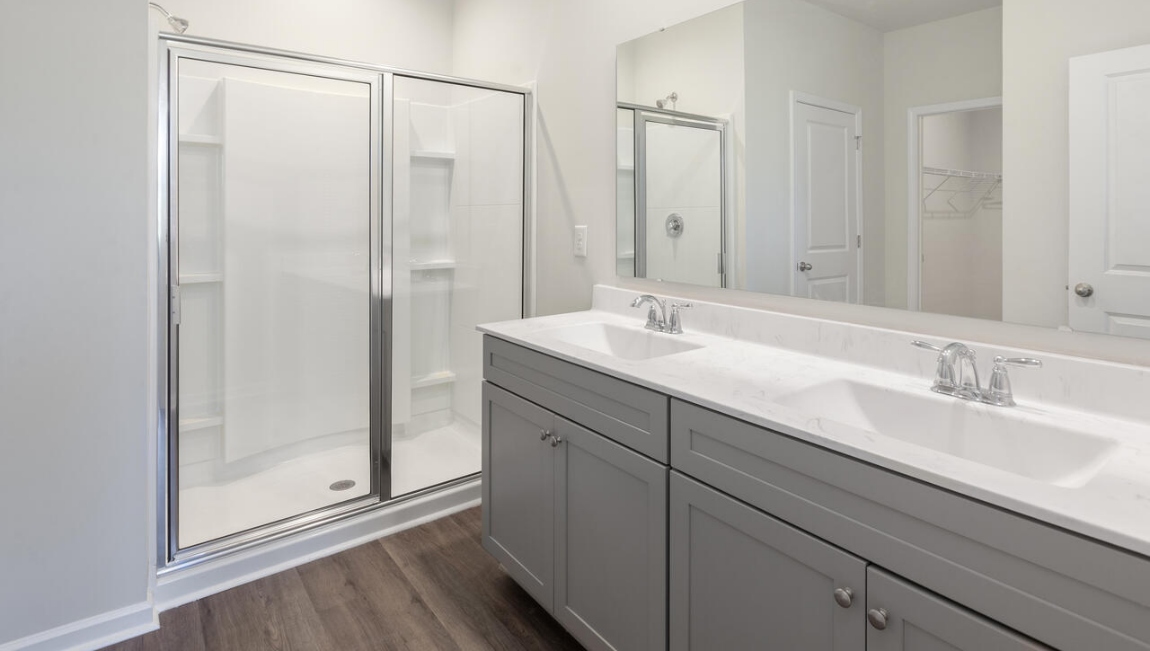 The primary bedroom has its own attached bathroom that features a walk-in closet and all the space you need to get ready in the morning.