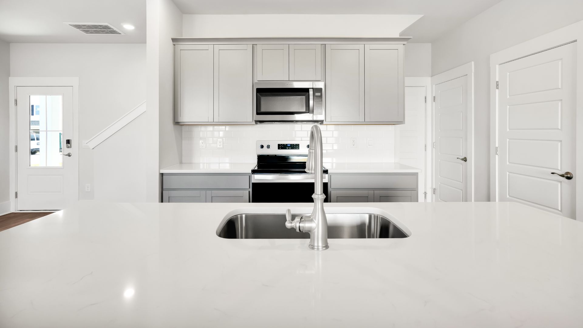 This impressive space features a family room, dining area, and modern kitchen. The kitchen is equipped with a pantry, stainless steel appliances, and a large island with a breakfast bar, making it perfect for both cooking and entertaining.