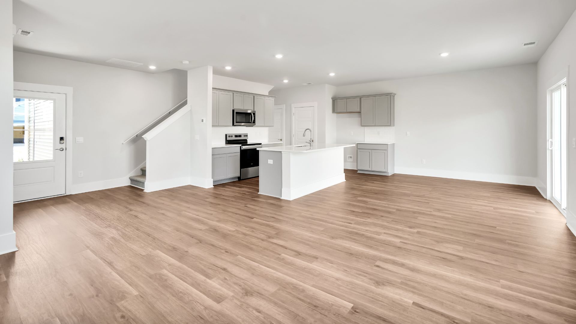 This impressive space features a family room, dining area, and modern kitchen. The kitchen is equipped with a pantry, stainless steel appliances, and a large island with a breakfast bar, making it perfect for both cooking and entertaining.This impressive space features a family room, dining area, and modern kitchen. The kitchen is equipped with a pantry, stainless steel appliances, and a large island with a breakfast bar, making it perfect for both cooking and entertaining.