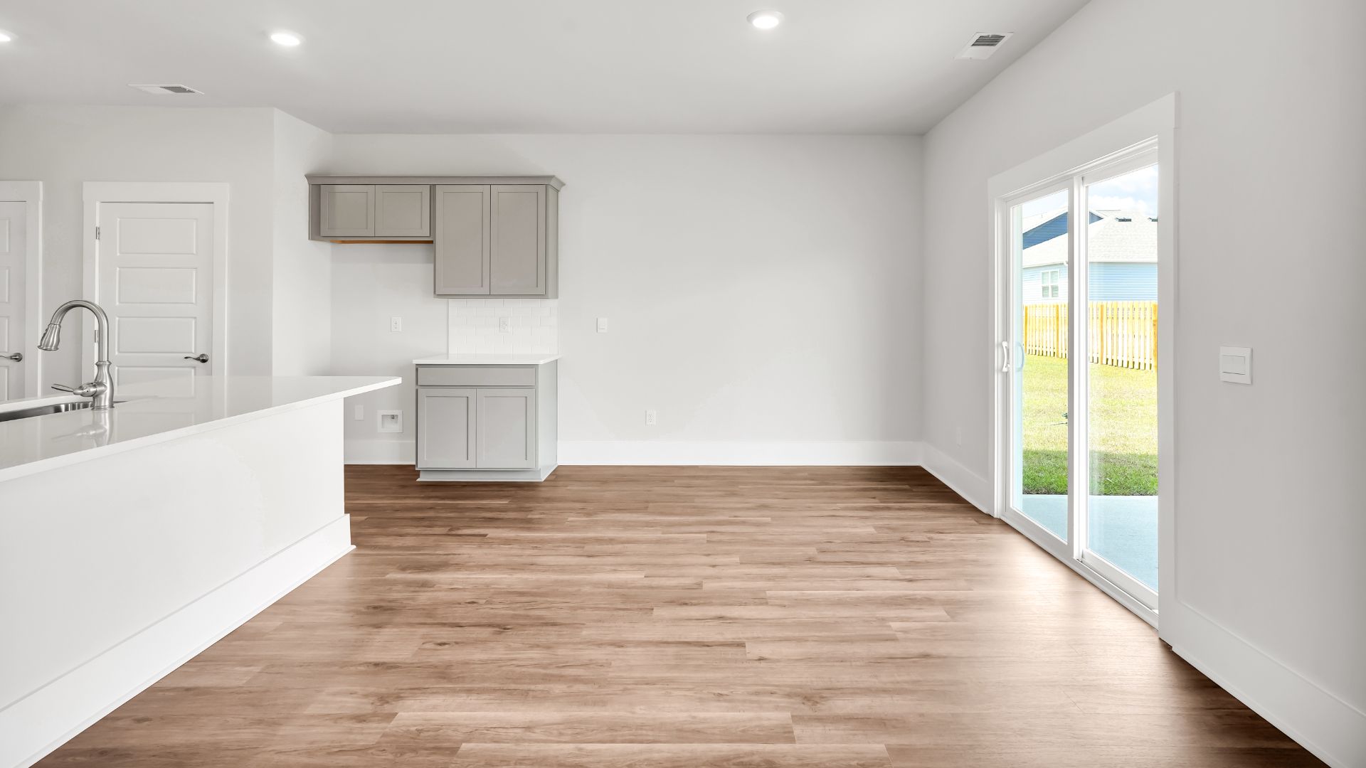This impressive space features a family room, dining area, and modern kitchen. The kitchen is equipped with a pantry, stainless steel appliances, and a large island with a breakfast bar, making it perfect for both cooking and entertaining.