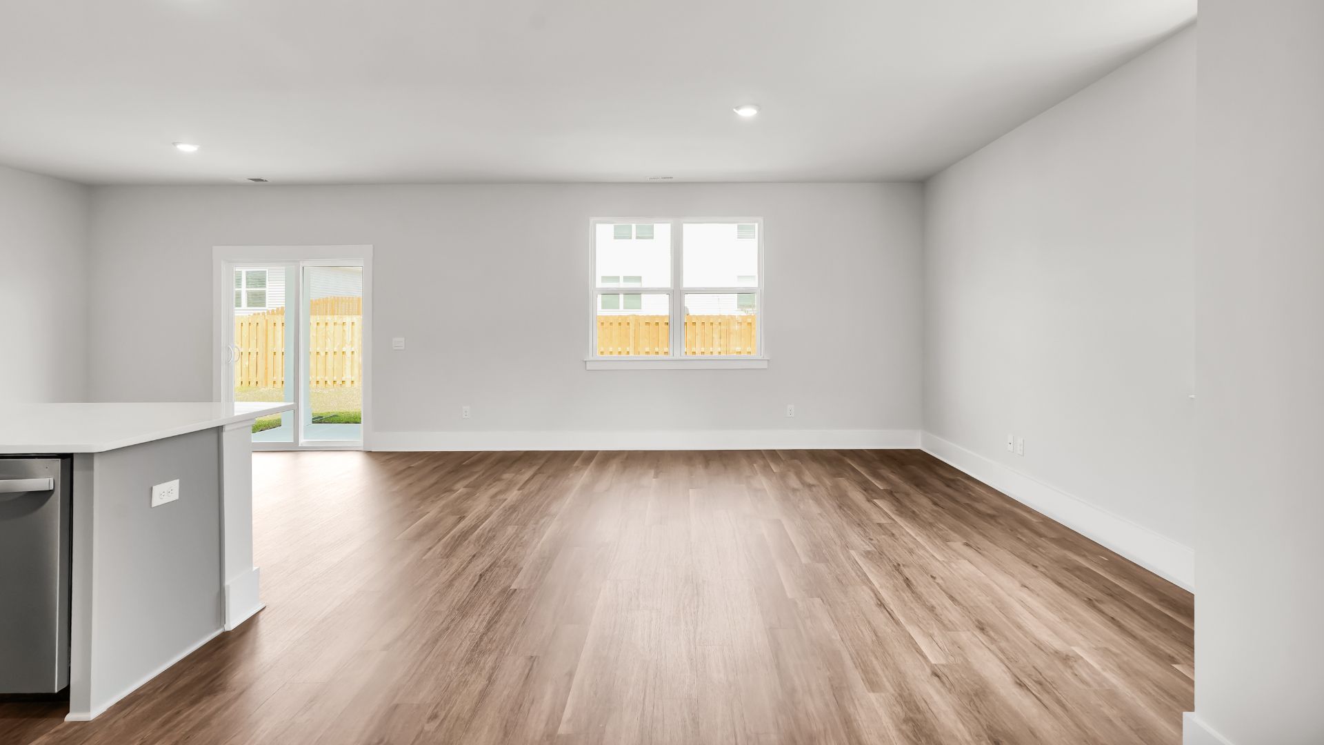 This impressive space features a family room, dining area, and modern kitchen. The kitchen is equipped with a pantry, stainless steel appliances, and a large island with a breakfast bar, making it perfect for both cooking and entertaining.