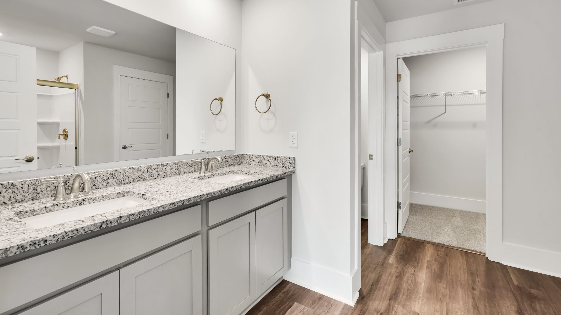 Upstairs this home also features a primary suite, complete with a large walk-in closet and en suite bathroom featuring dual vanities and a spacious shower. The additional three bedrooms share a full bath that includes dual vanities.