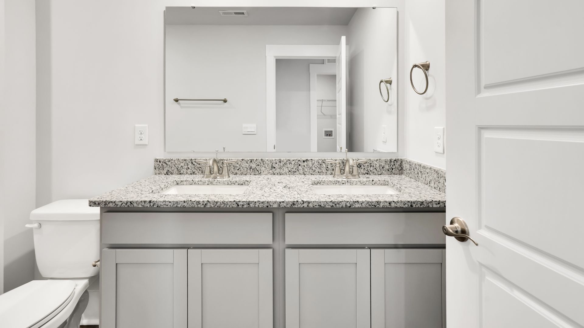 Upstairs this home also features a primary suite, complete with a large walk-in closet and en suite bathroom featuring dual vanities and a spacious shower. The additional three bedrooms share a full bath that includes dual vanities.