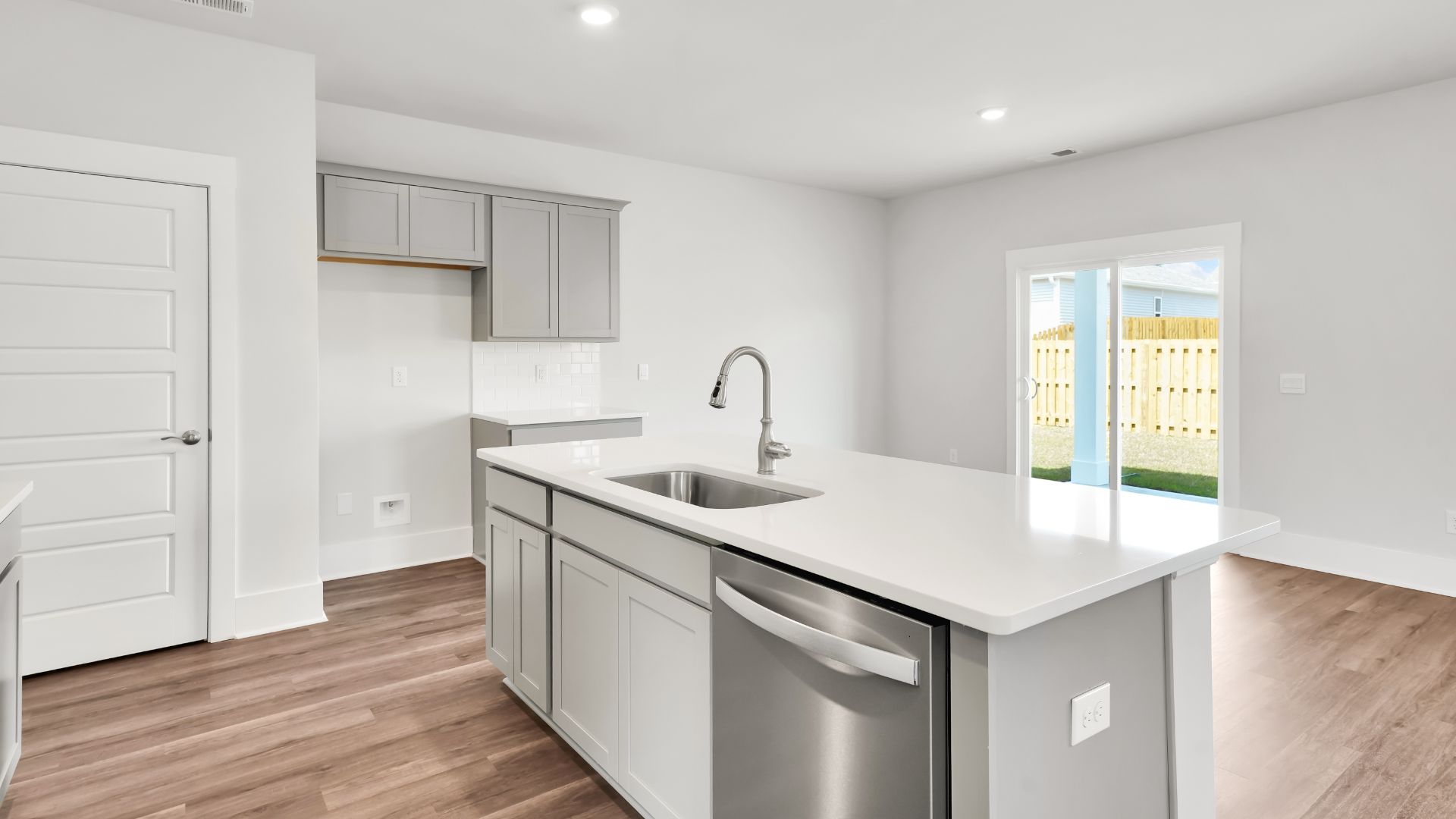 This impressive space features a family room, dining area, and modern kitchen. The kitchen is equipped with a pantry, stainless steel appliances, and a large island with a breakfast bar, making it perfect for both cooking and entertaining.