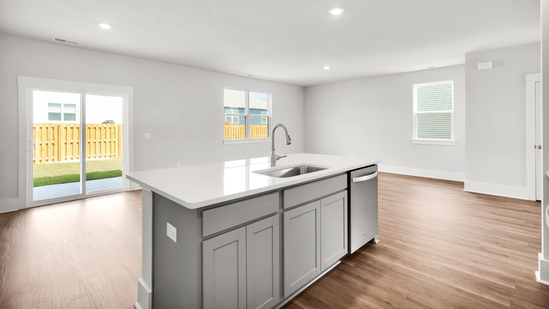This impressive space features a family room, dining area, and modern kitchen. The kitchen is equipped with a pantry, stainless steel appliances, and a large island with a breakfast bar, making it perfect for both cooking and entertaining.