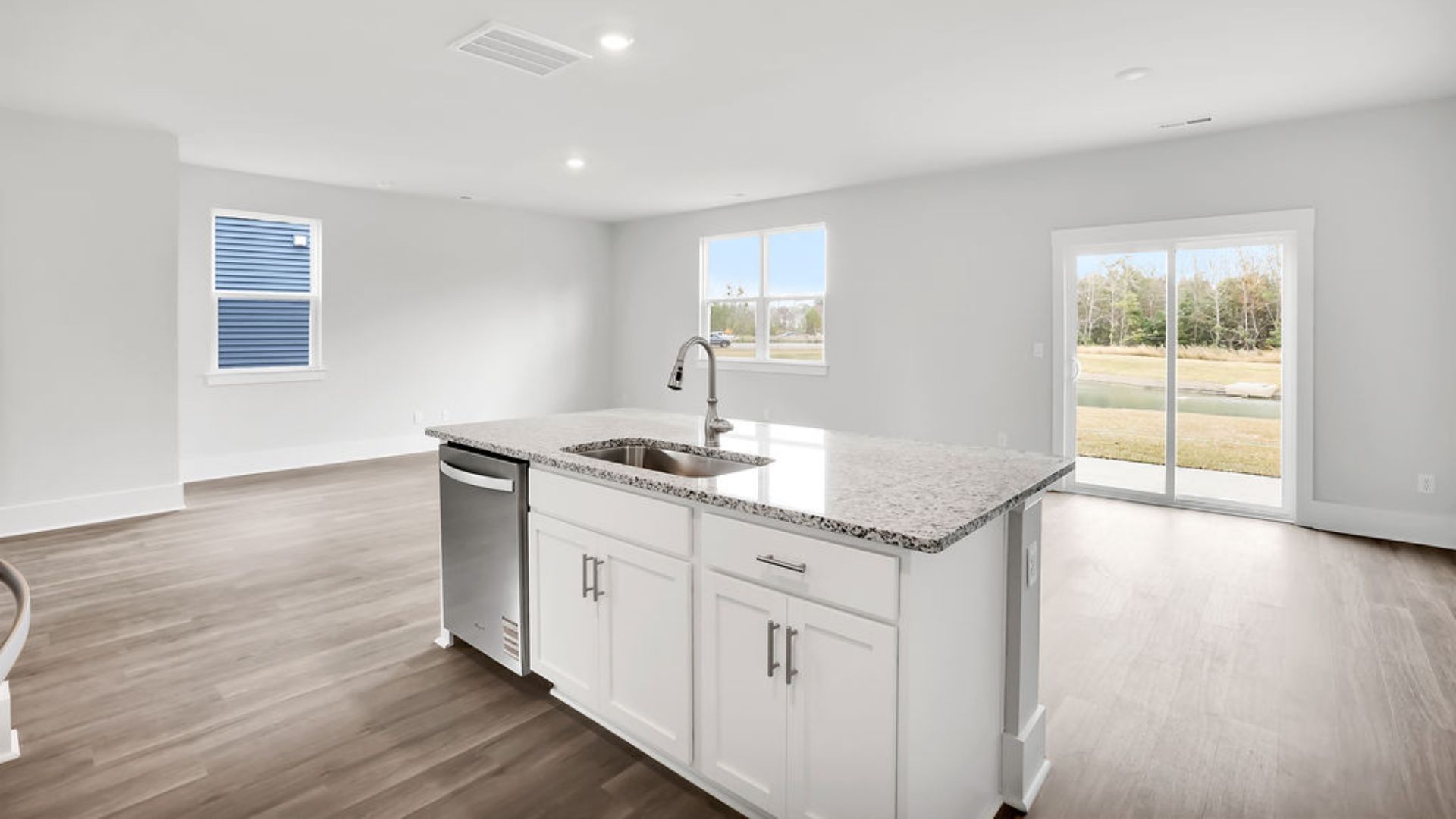 This impressive space features a family room, dining area, and modern kitchen. The kitchen is equipped with a pantry, stainless steel appliances, and a large island with a breakfast bar, making it perfect for both cooking and entertaining