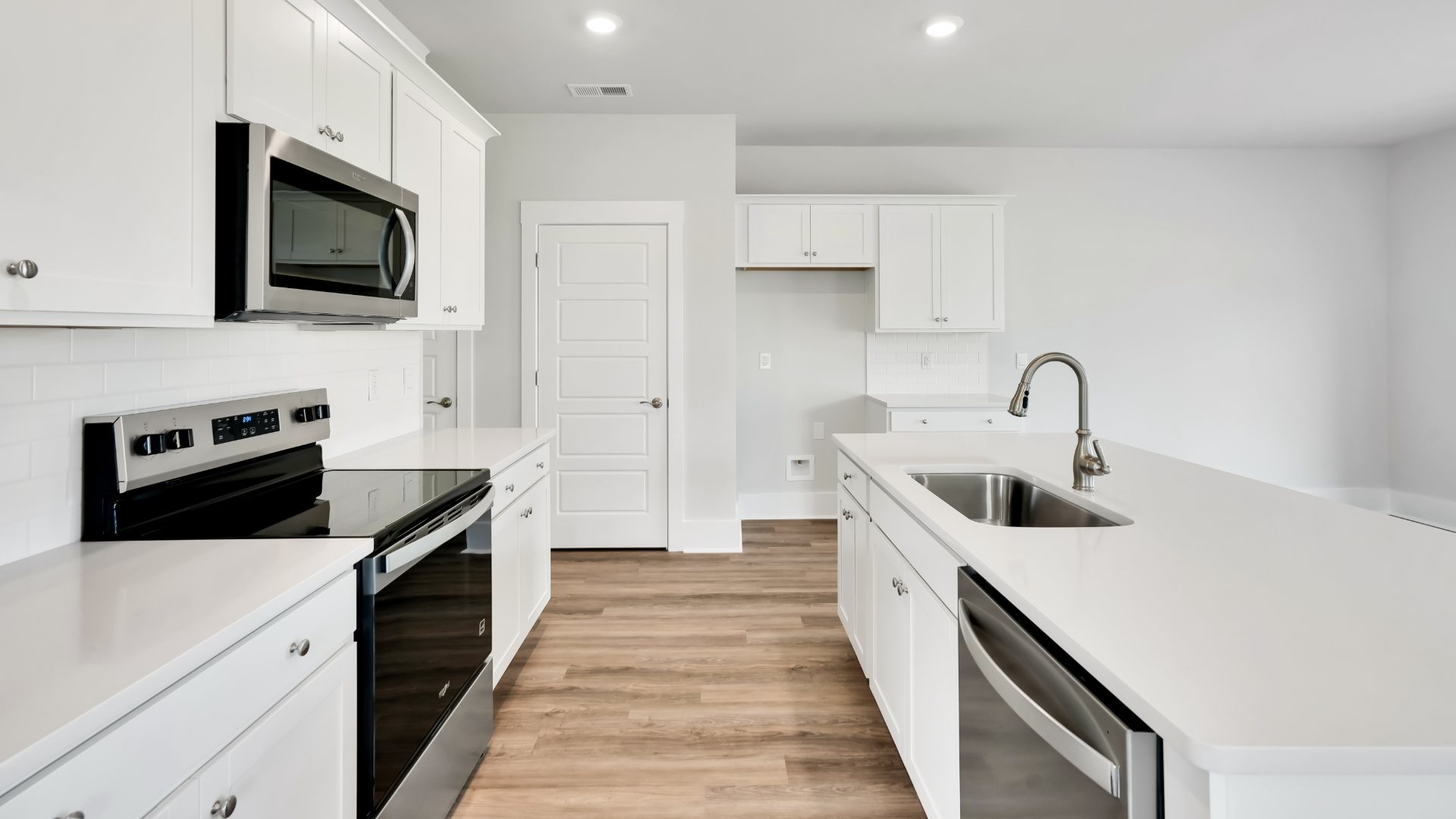 The kitchen features shaker-style cabinets, granite countertops, and stainless steel appliances, which are sure to both turn heads and make meal prep easy
