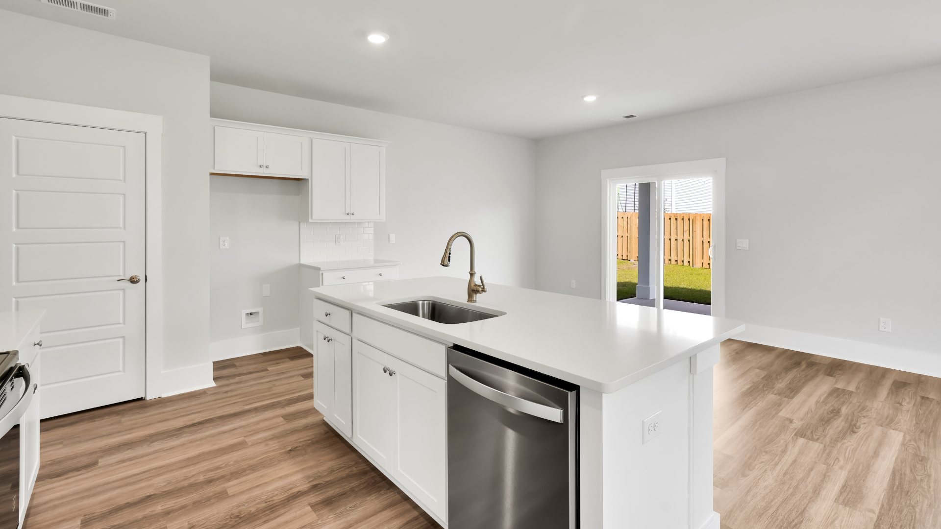 The kitchen features shaker-style cabinets, granite countertops, and stainless steel appliances, which are sure to both turn heads and make meal prep easy
