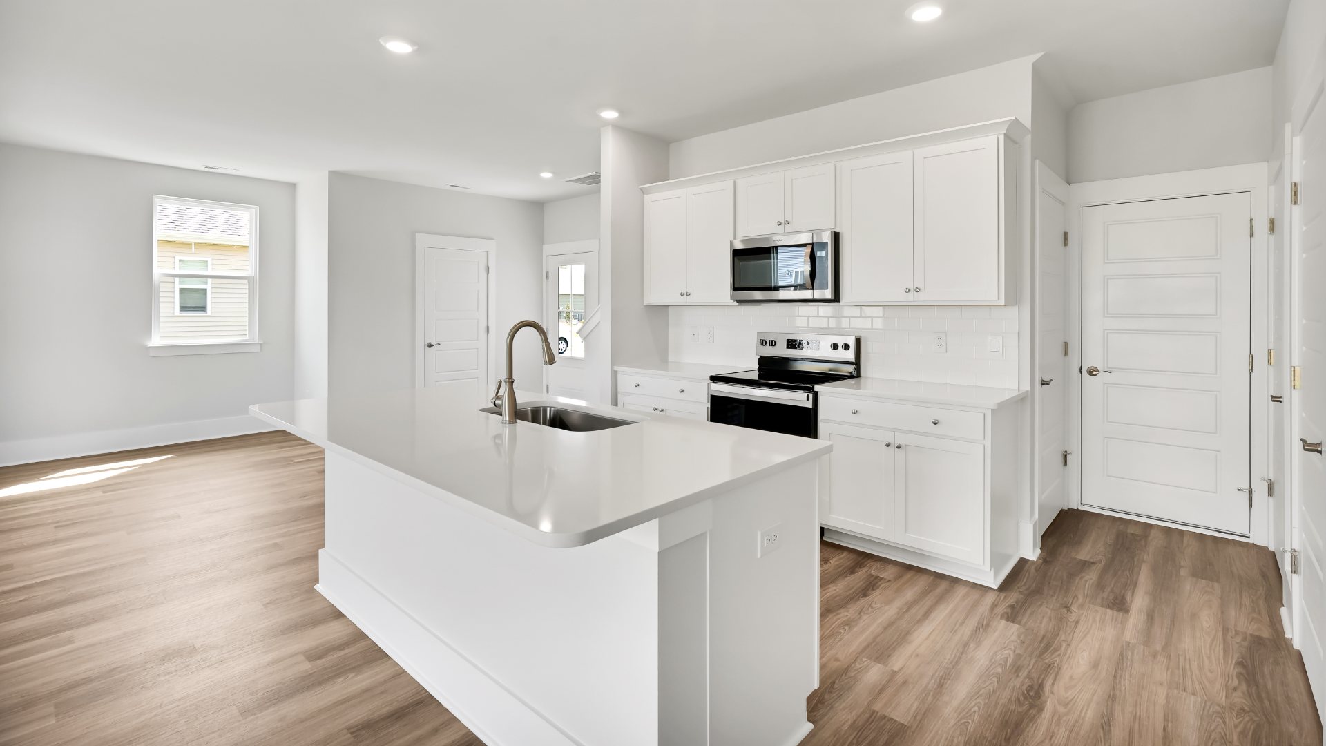 The kitchen features shaker-style cabinets, granite countertops, and stainless steel appliances, which are sure to both turn heads and make meal prep easy