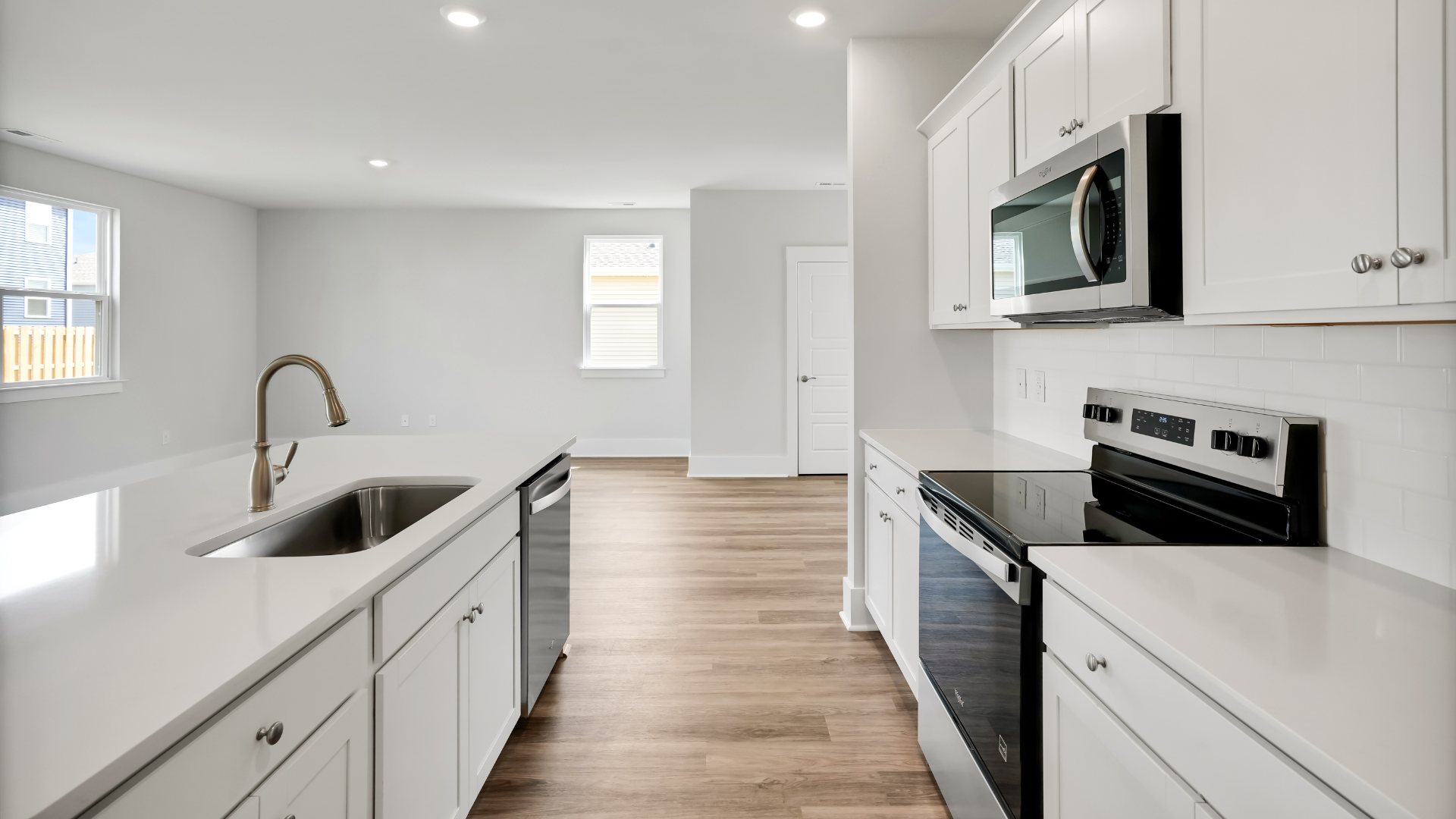The kitchen features shaker-style cabinets, granite countertops, and stainless steel appliances, which are sure to both turn heads and make meal prep easy