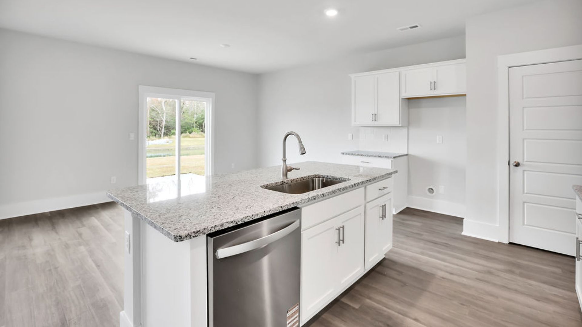 The kitchen features shaker-style cabinets, granite countertops, and stainless steel appliances, which are sure to both turn heads and make meal prep easy. You’ll never be too far from the action with the living and dining area right there.