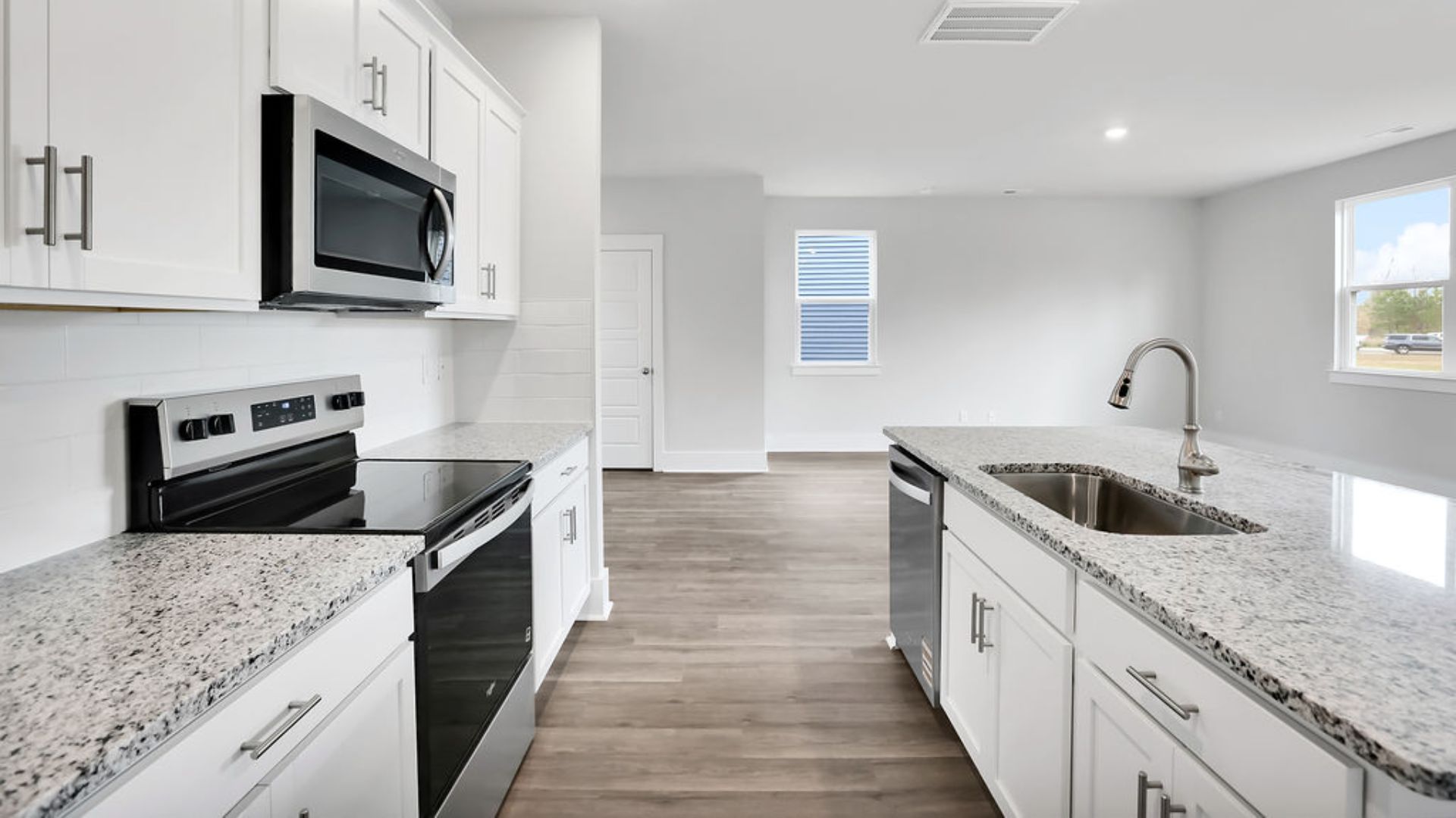 The kitchen features shaker-style cabinets, granite countertops, and stainless steel appliances, which are sure to both turn heads and make meal prep easy. You’ll never be too far from the action with the living and dining area right there.