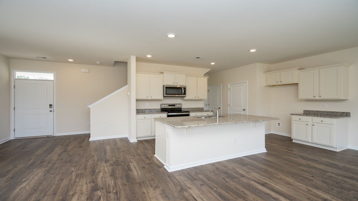 The kitchen features 36" cabinets, granite countertops, and stainless steel appliances, which are sure to both turn heads and make meal prep easy. Y