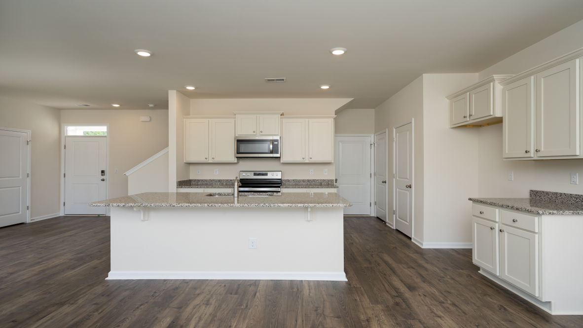 The kitchen features 36" cabinets, granite countertops, and stainless steel appliances, which are sure to both turn heads and make meal prep easy. Y