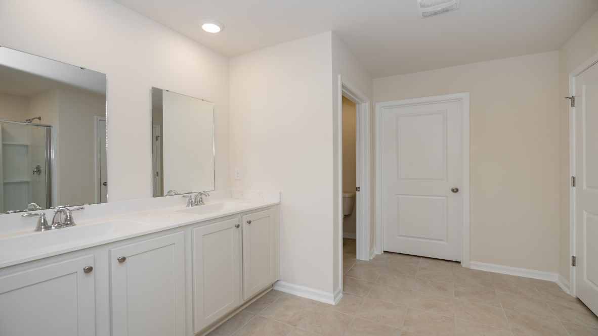 The primary bedroom has its own attached bathroom that features a walk-in closet and all the space you need to get ready in the morning.