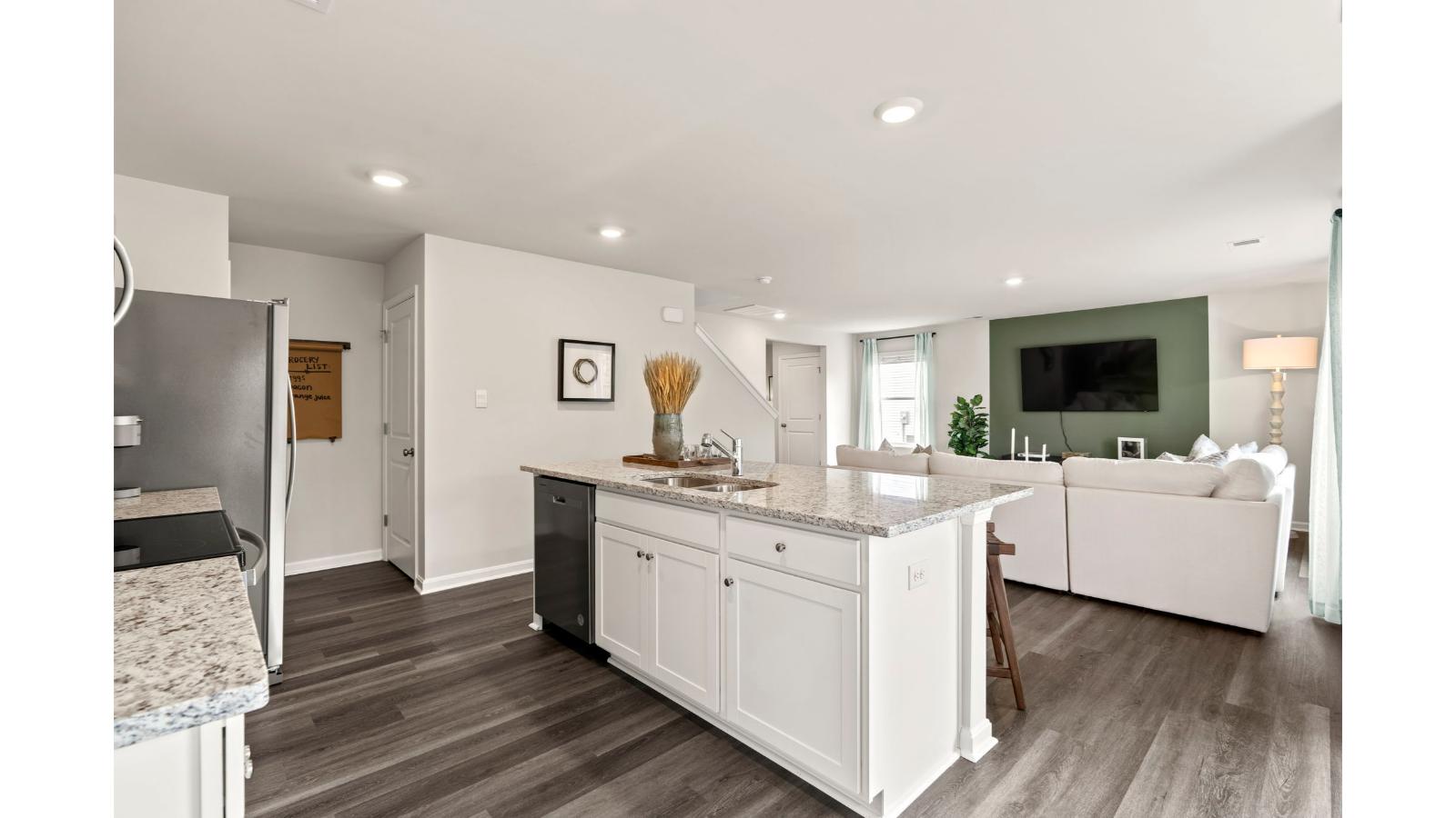 The spacious kitchen has a large island with room for seating, an impressive corner pantry, plenty of cabinet space and stainless-steel appliances. The kitchen has an eat-in dining area with a sliding glass door for easy access to the backyard.
