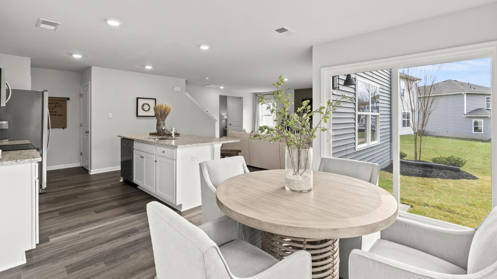 The spacious kitchen has a large island with room for seating, an impressive corner pantry, plenty of cabinet space and stainless-steel appliances. The kitchen has an eat-in dining area with a sliding glass door for easy access to the backyard.