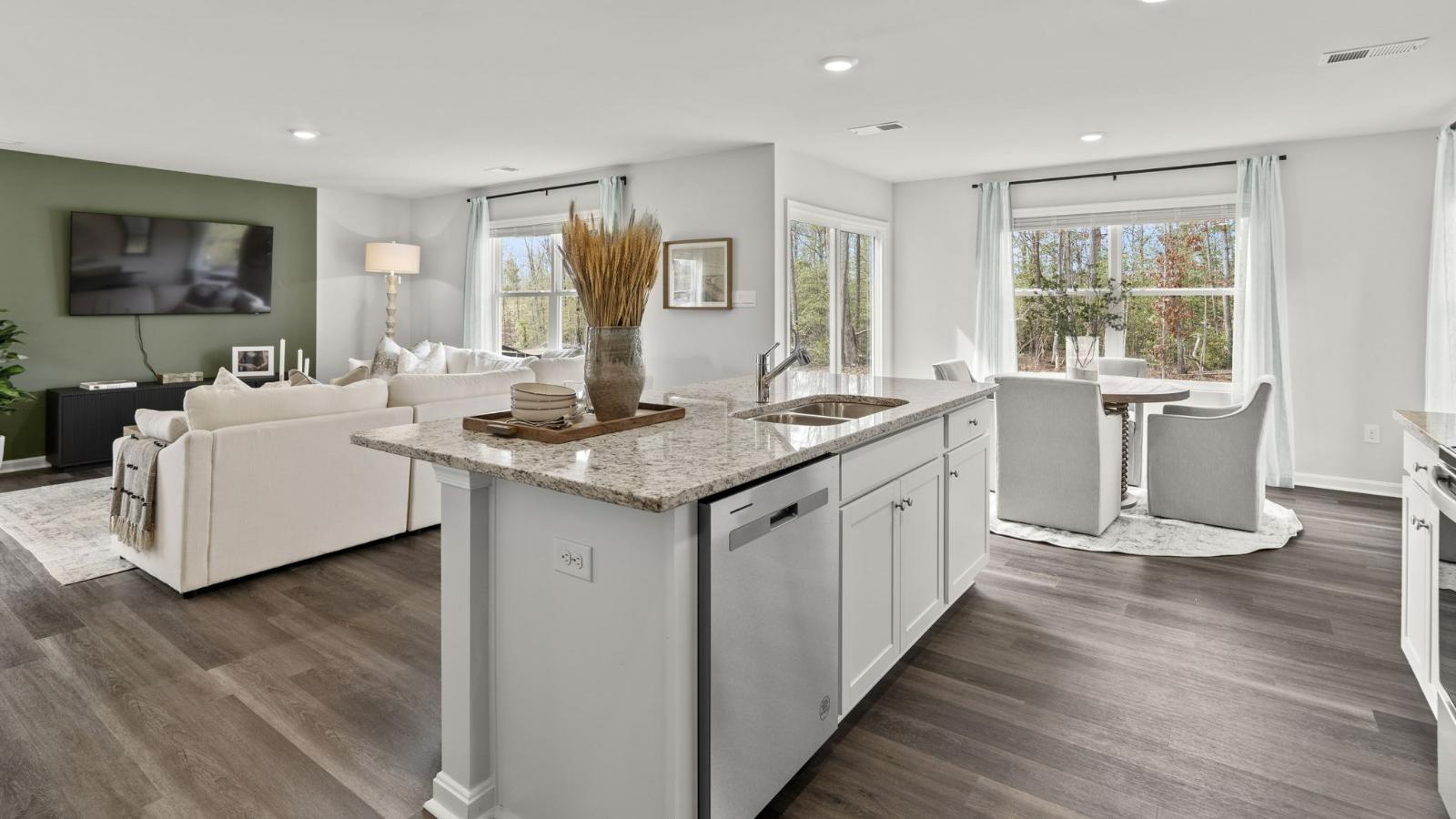 The spacious kitchen has a large island with room for seating, an impressive corner pantry, plenty of cabinet space and stainless-steel appliances. The kitchen has an eat-in dining area with a sliding glass door for easy access to the backyard.