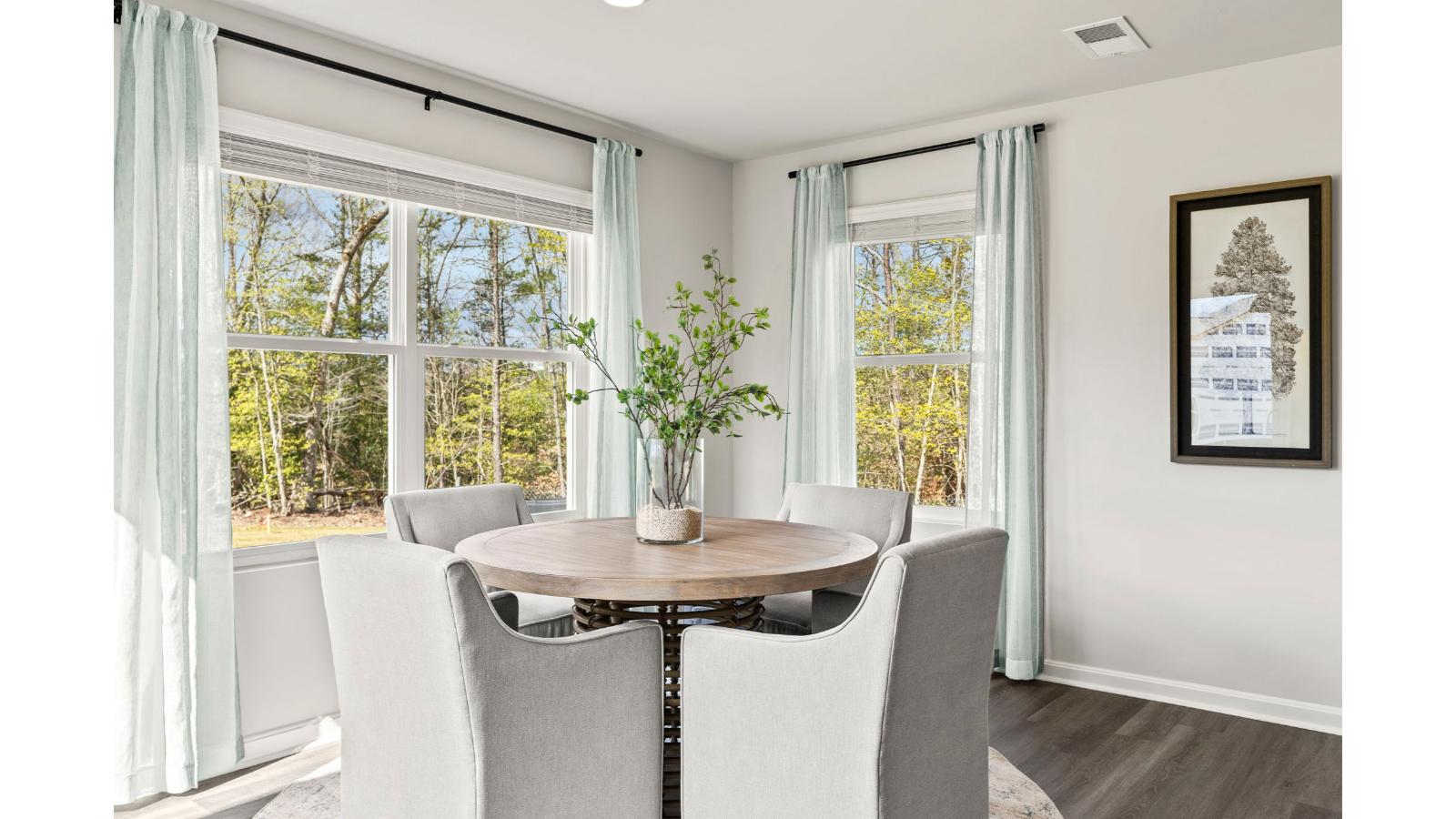 The spacious kitchen has a large island with room for seating, an impressive corner pantry, plenty of cabinet space and stainless-steel appliances. The kitchen has an eat-in dining area with a sliding glass door for easy access to the backyard.