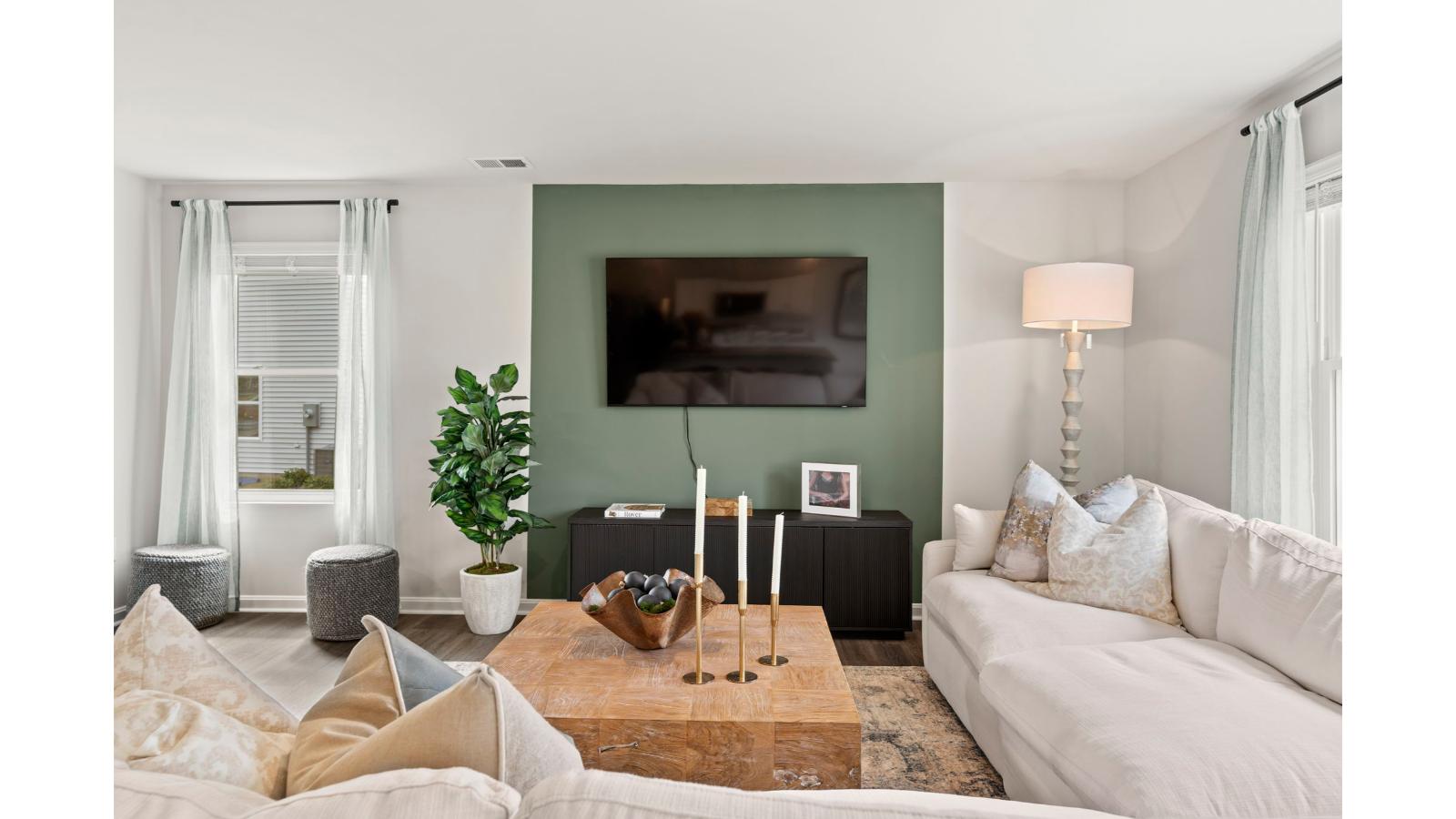 The spacious kitchen has a large island with room for seating, an impressive corner pantry, plenty of cabinet space and stainless-steel appliances. The kitchen has an eat-in dining area with a sliding glass door for easy access to the backyard.