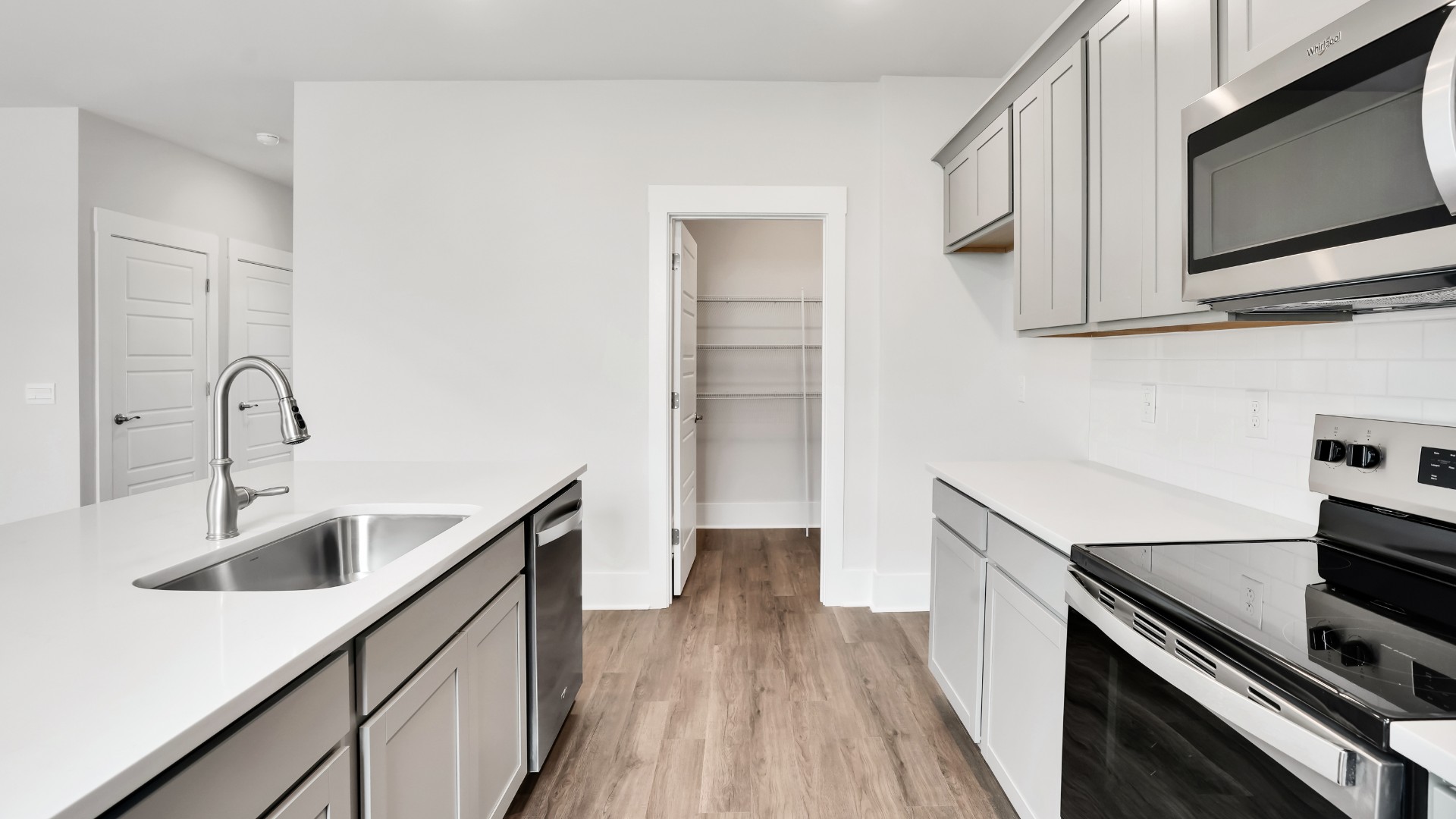 The kitchen features a large island and stainless steel appliances, which are sure to both turn heads and make meal prep easy. You’ll never be too far from the action with the living and dining area right there.