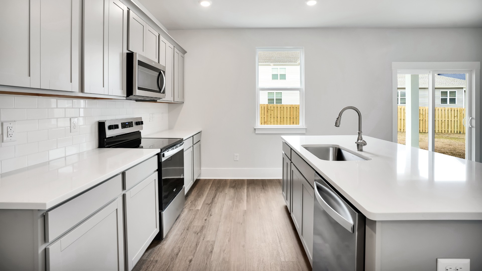 The kitchen features a large island and stainless steel appliances, which are sure to both turn heads and make meal prep easy. You’ll never be too far from the action with the living and dining area right there.