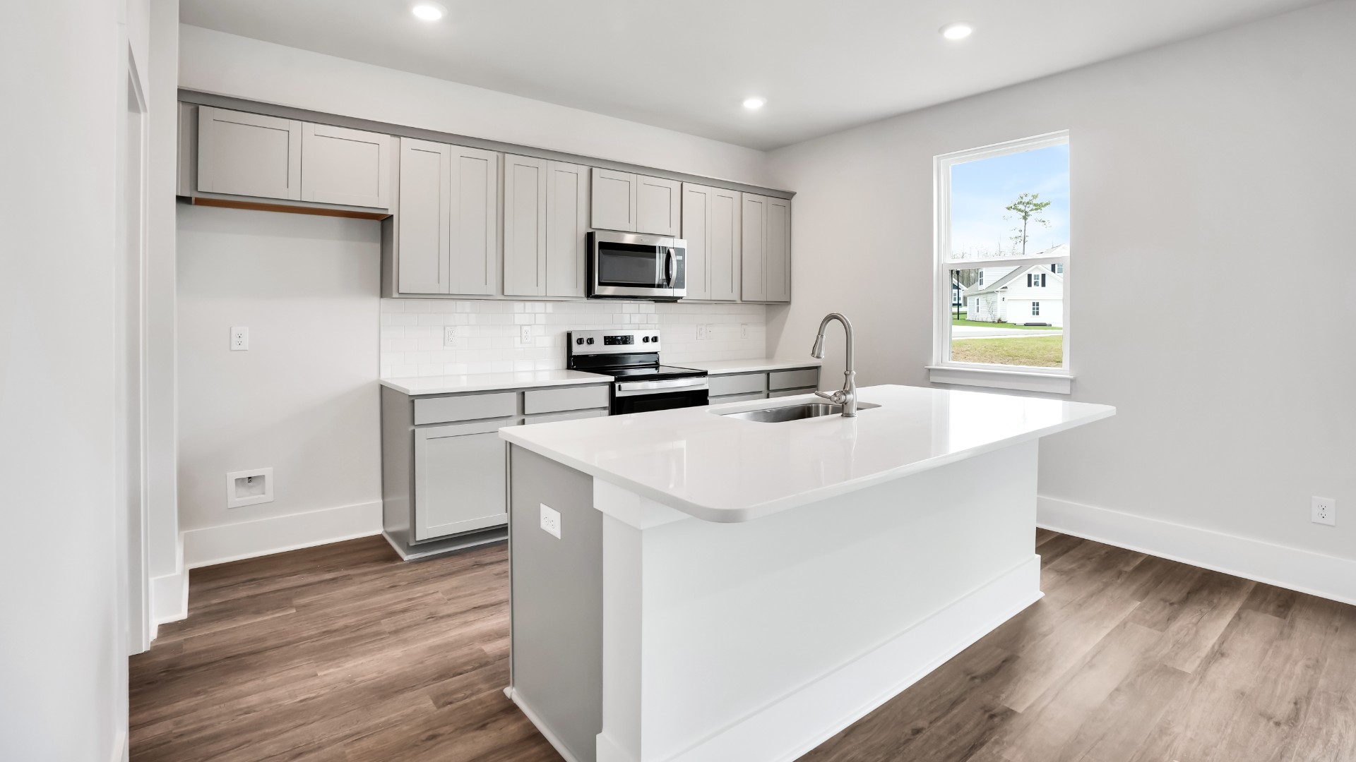 The kitchen features a large island and stainless steel appliances, which are sure to both turn heads and make meal prep easy. You’ll never be too far from the action with the living and dining area right there.