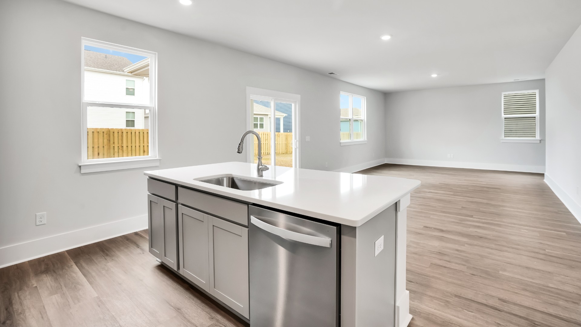 The kitchen features a large island and stainless steel appliances, which are sure to both turn heads and make meal prep easy. You’ll never be too far from the action with the living and dining area right there.