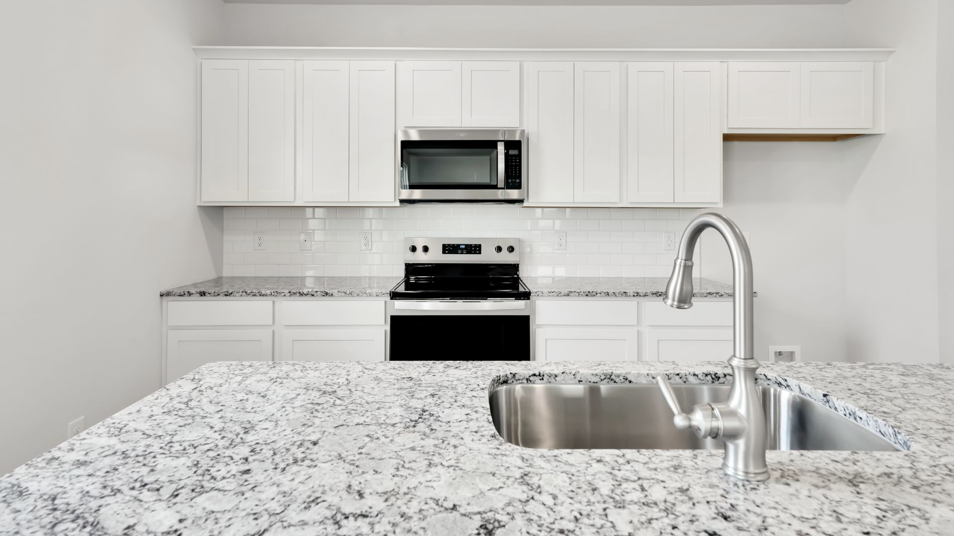 The kitchen features a large island and stainless steel appliances, which are sure to both turn heads and make meal prep easy. You’ll never be too far from the action with the living and dining area right there.