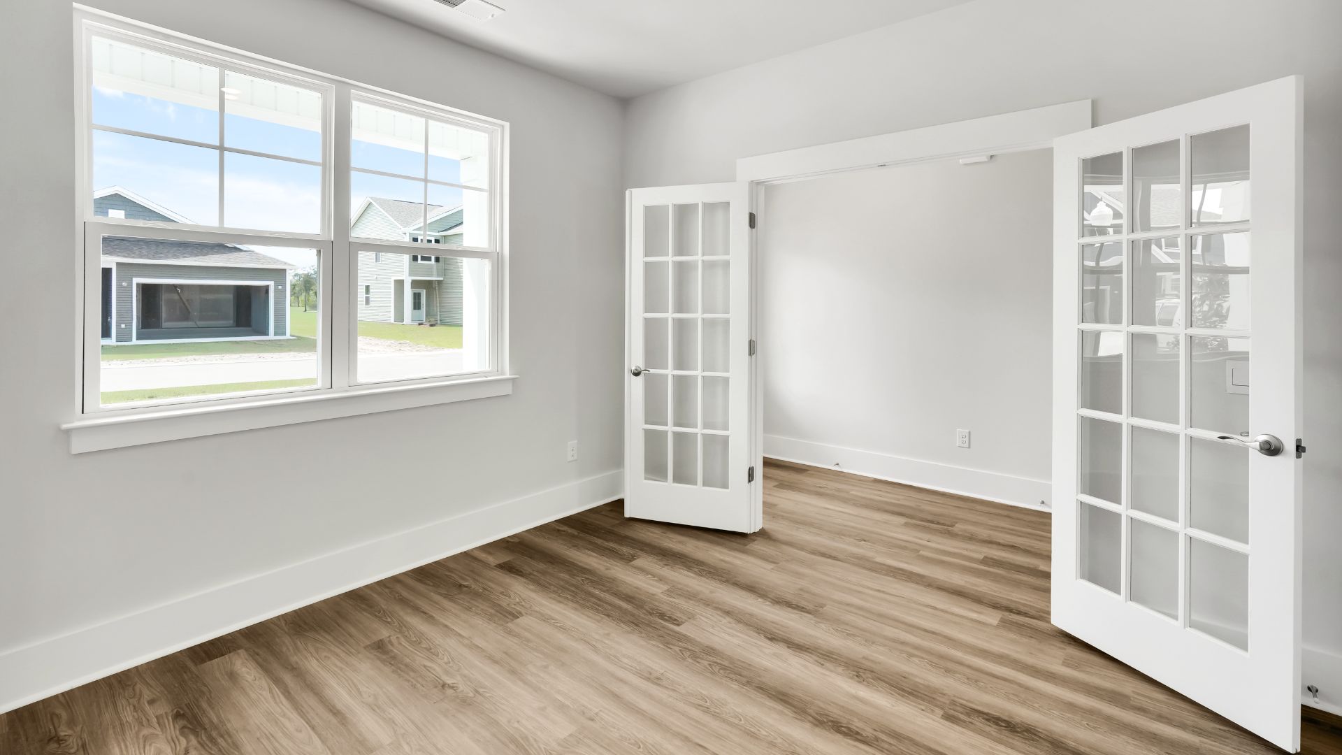At the front of the home is a flex room and half bath.