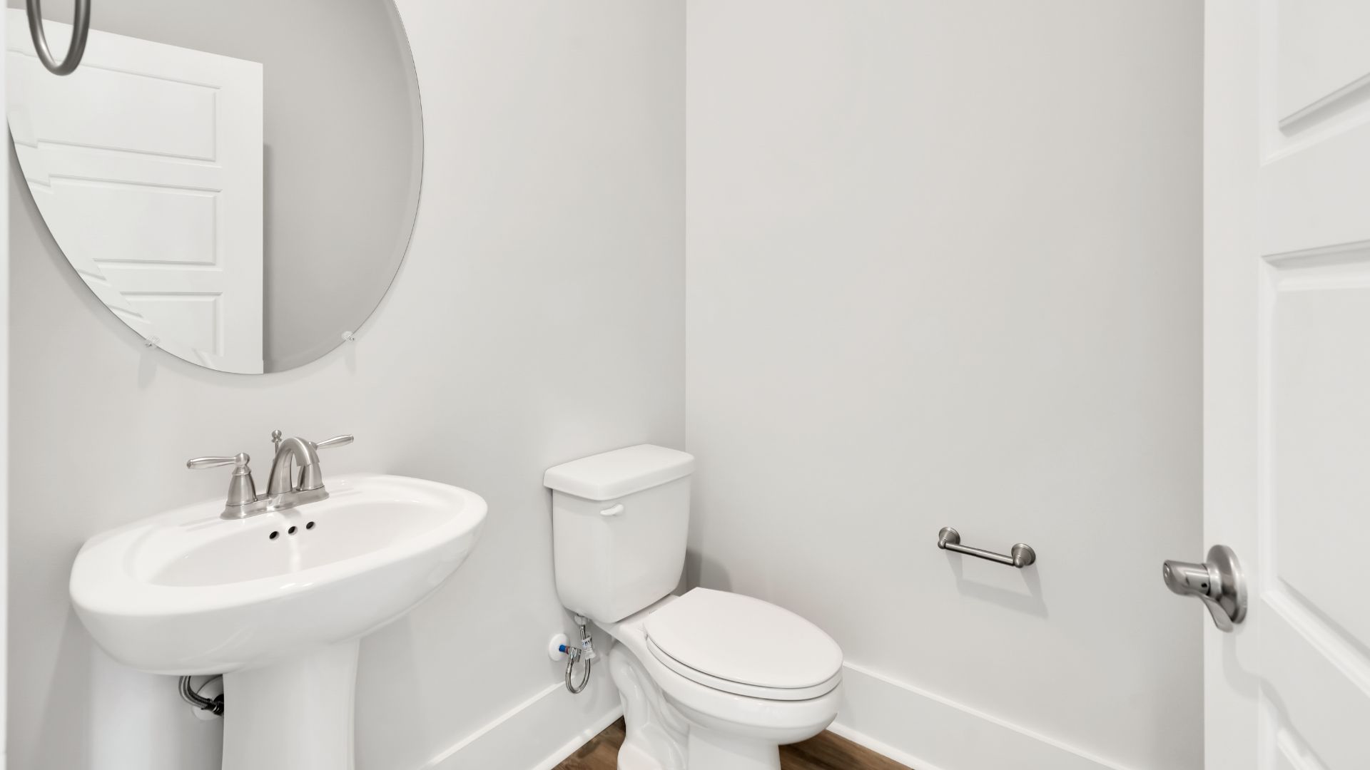 At the front of the home is a flex room and half bath.