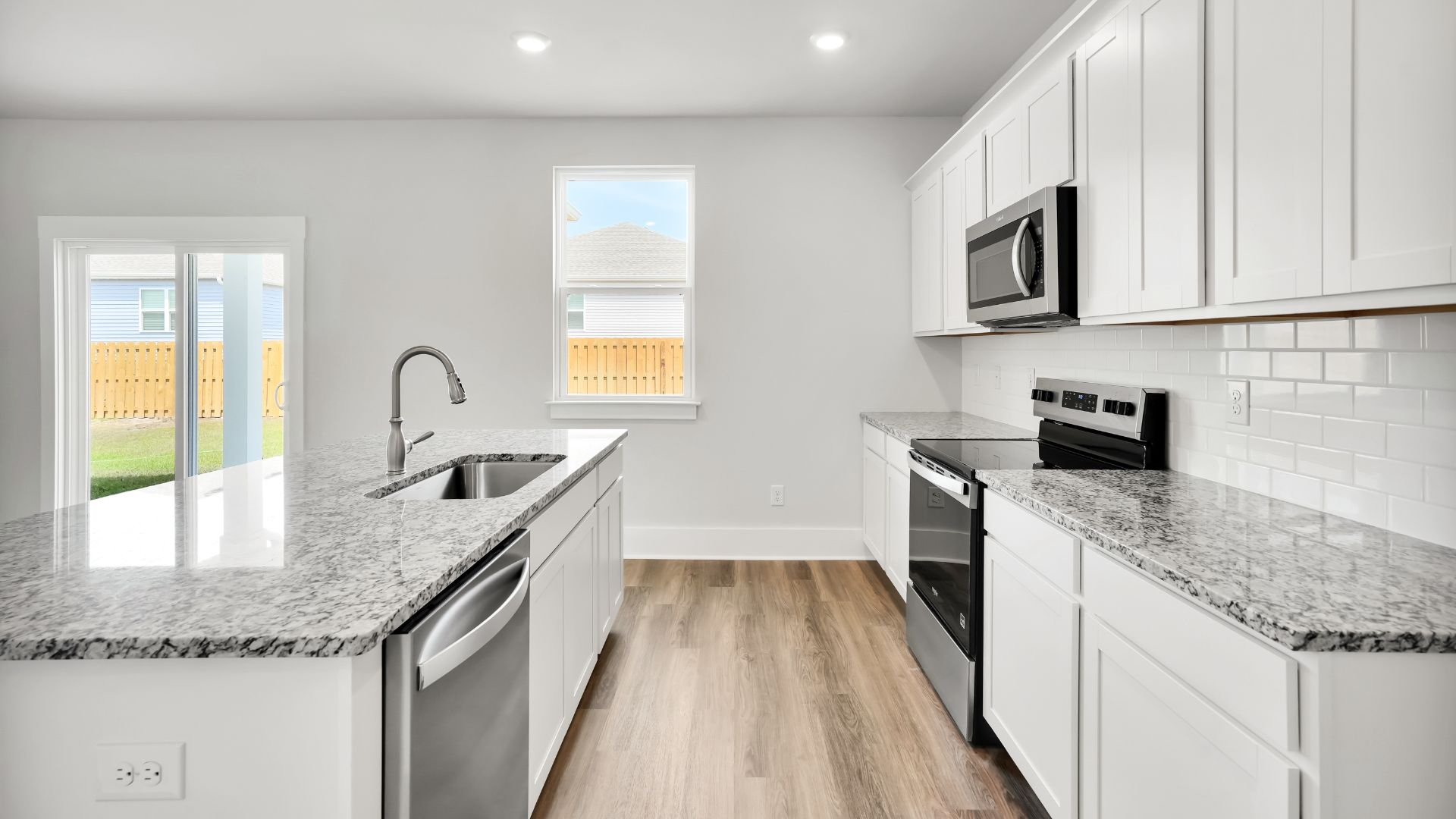 The kitchen features a large island and stainless steel appliances, which are sure to both turn heads and make meal prep easy. You’ll never be too far from the action with the living and dining area right there.