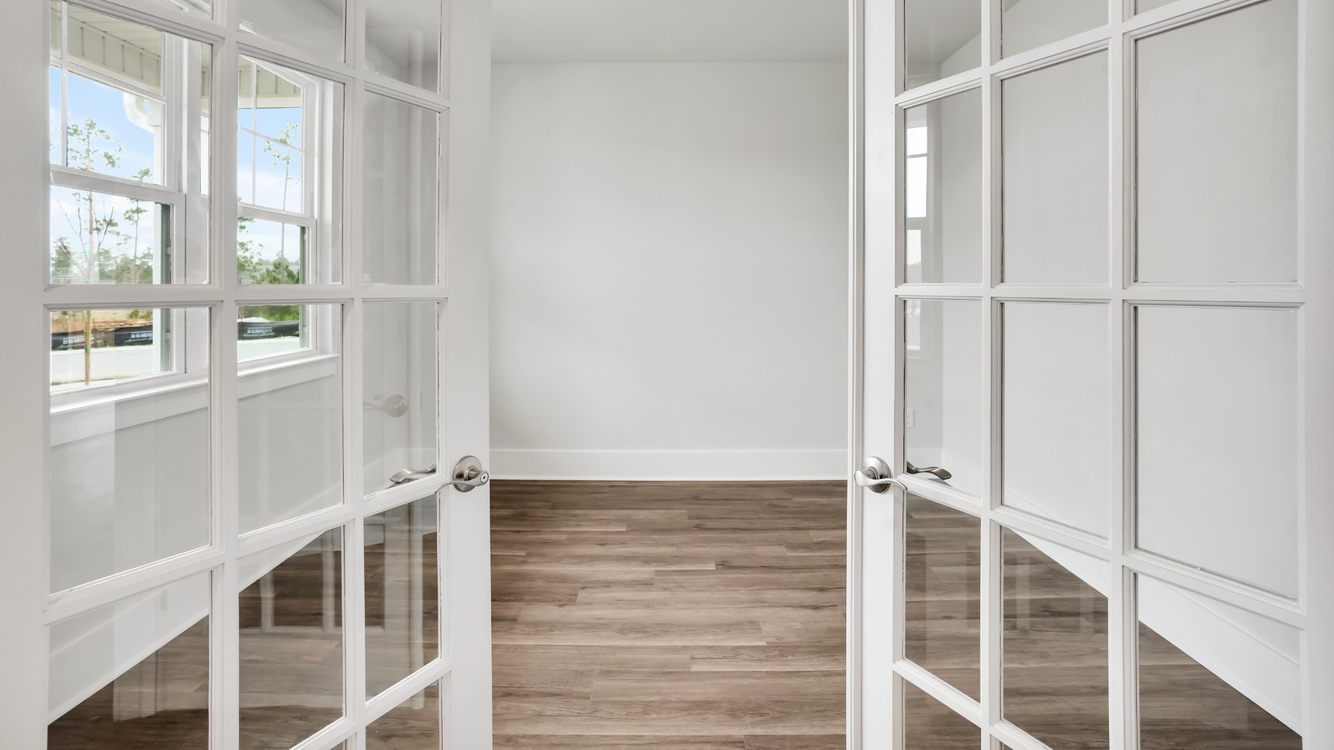At the front of the home is a flex room and half bath.