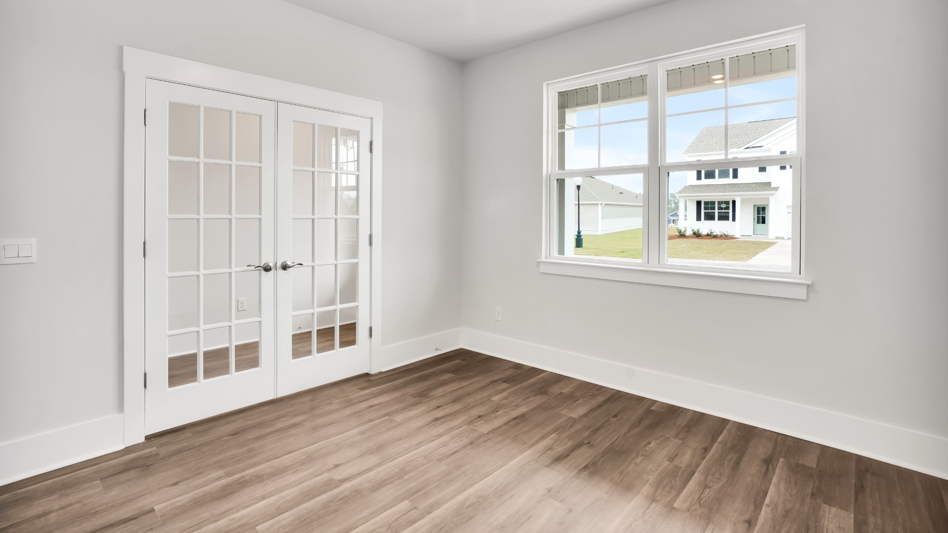 At the front of the home is a flex room and half bath.