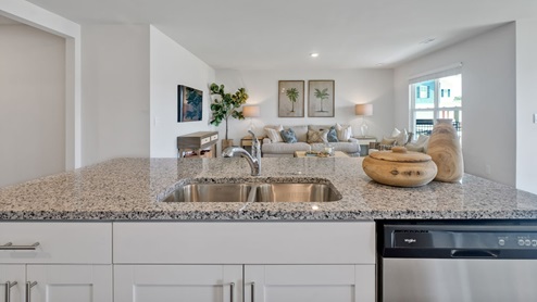 The kitchen features a large island, granite countertops, and stainless steel appliances, which are sure to both turn heads and make meal prep easy. You’ll never be too far from the action with the living and dining area right there.
