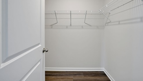The Primary Suite offers a massive closet and a luxurious bathroom with a walk-in shower, linen closet, and dual vanity.