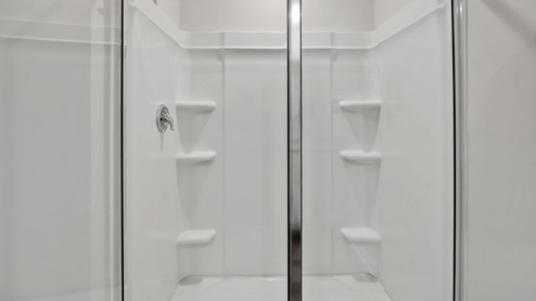 The Primary Suite offers a massive closet and a luxurious bathroom with a walk-in shower, linen closet, and dual vanity.